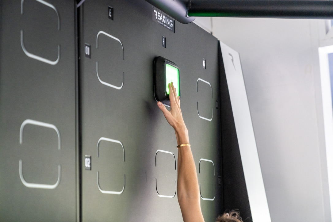 Guest placing a hand on the body composition scanner in the performance centre