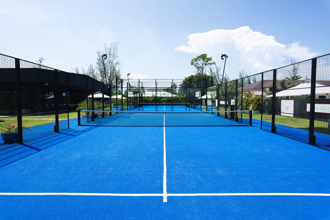Blue padel court under an open sky on the estate